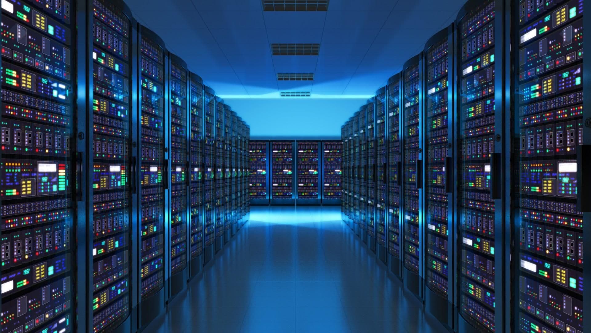 Rows of lit server racks in a data center aisle
